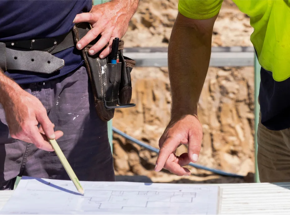 Builder reviewing estimating documents